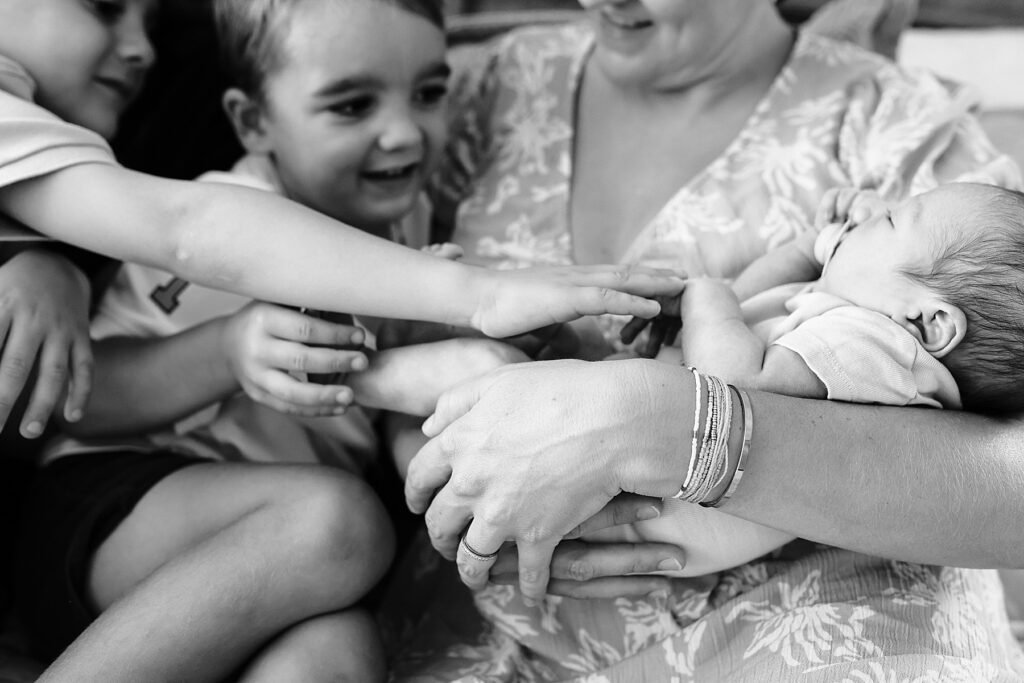 when should I book newborn photos - baby with family
